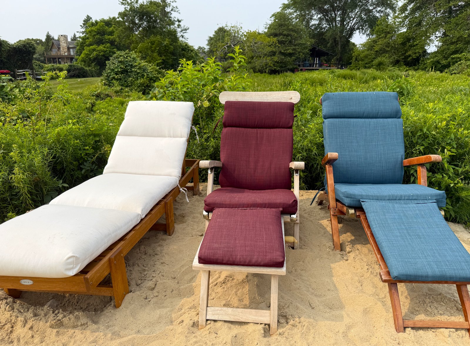 waterside lounging on sand three lounge chairs on sand by the water -- two steamers and one chaise