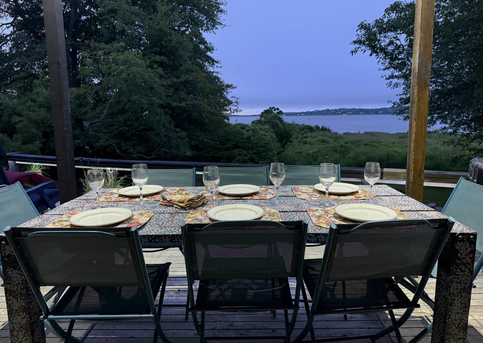 outdoor dining table at dusk under the covered deck
