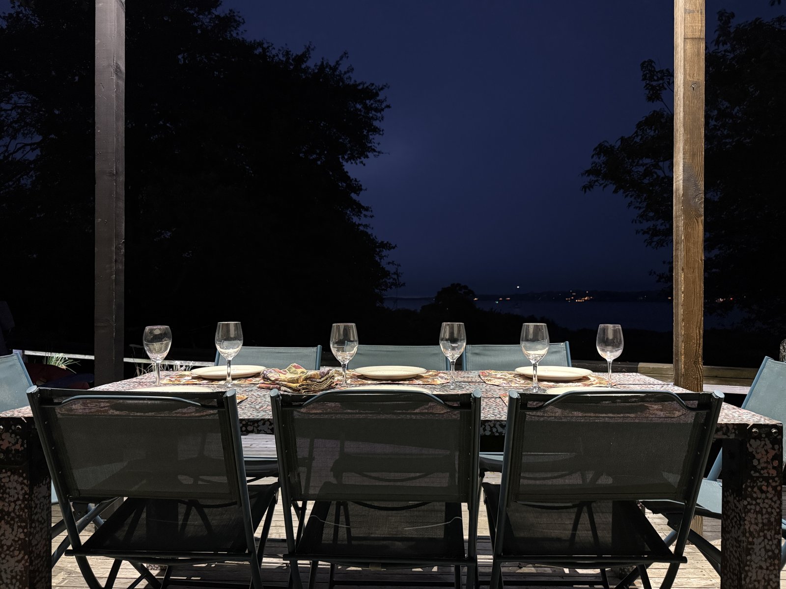illuminated outside dining table on the covered deck at night